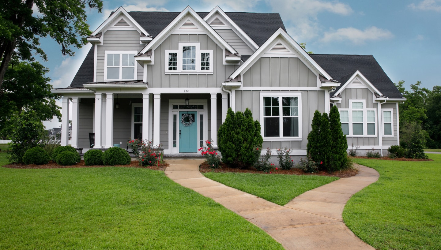 beautiful home with nice green grass and asphalt shingle roof