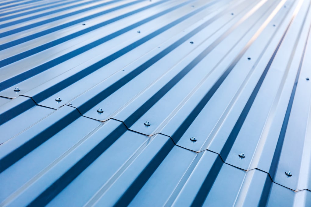 standing seam vs. exposed fastener metal roofing blue