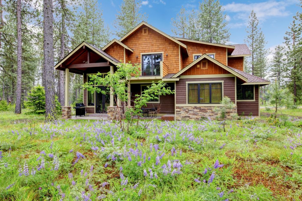 Mountain cabin home with wood siding and brown roof color combinations