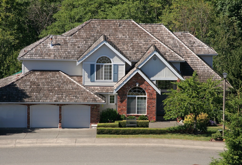 luxury house with cedar shake roofing