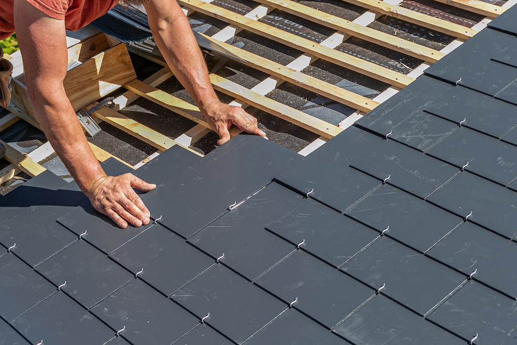 workers installing slate roof 