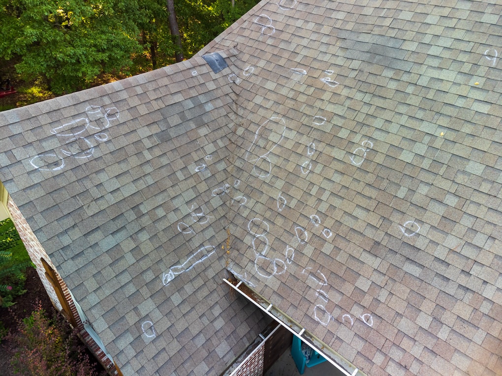 Roof with hail damage and markings from inspection roof claim