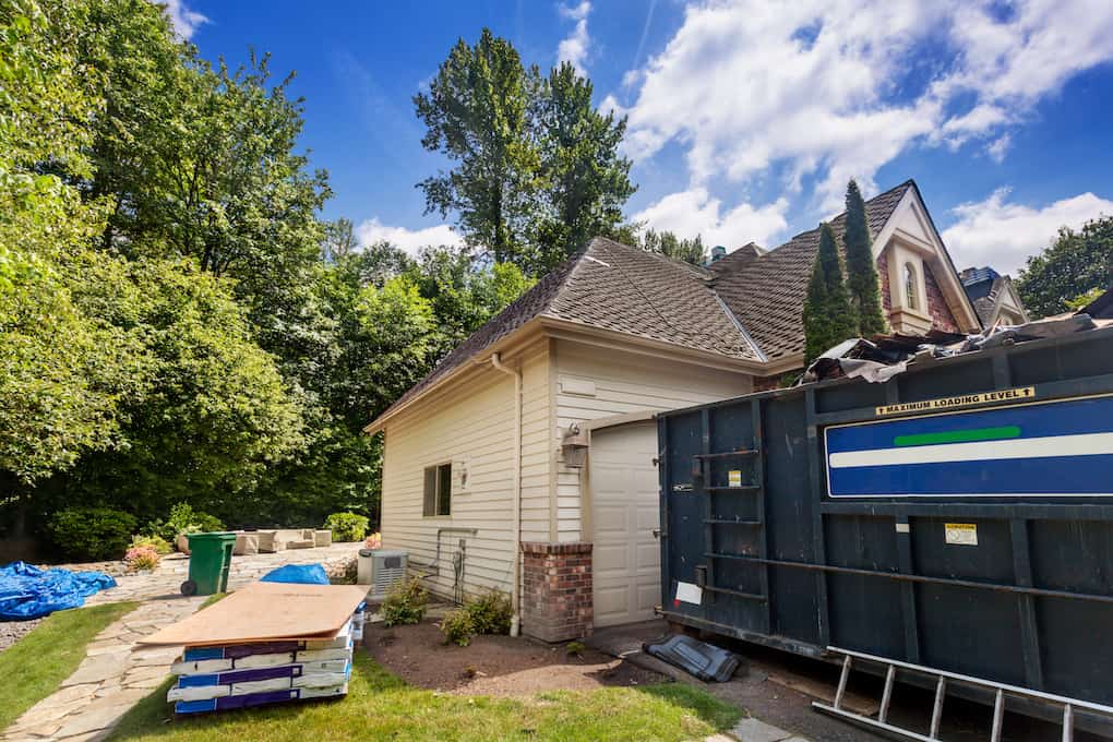 large rental dumpster outside of residential home; roof installation tips
