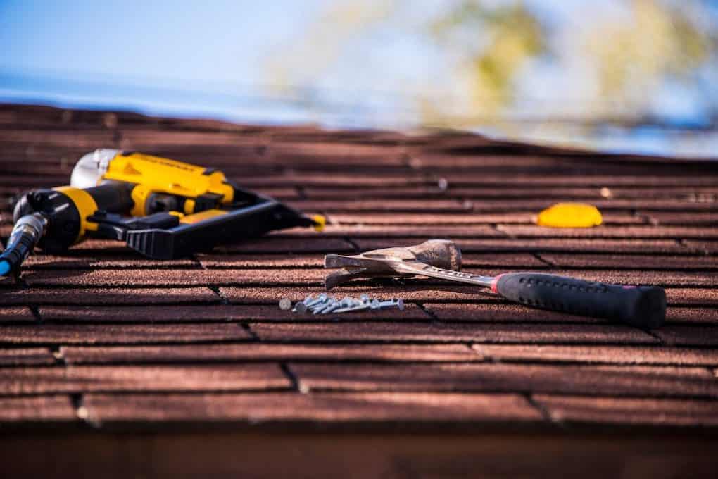 roofing tools laying on shingle roof; roof installation tips