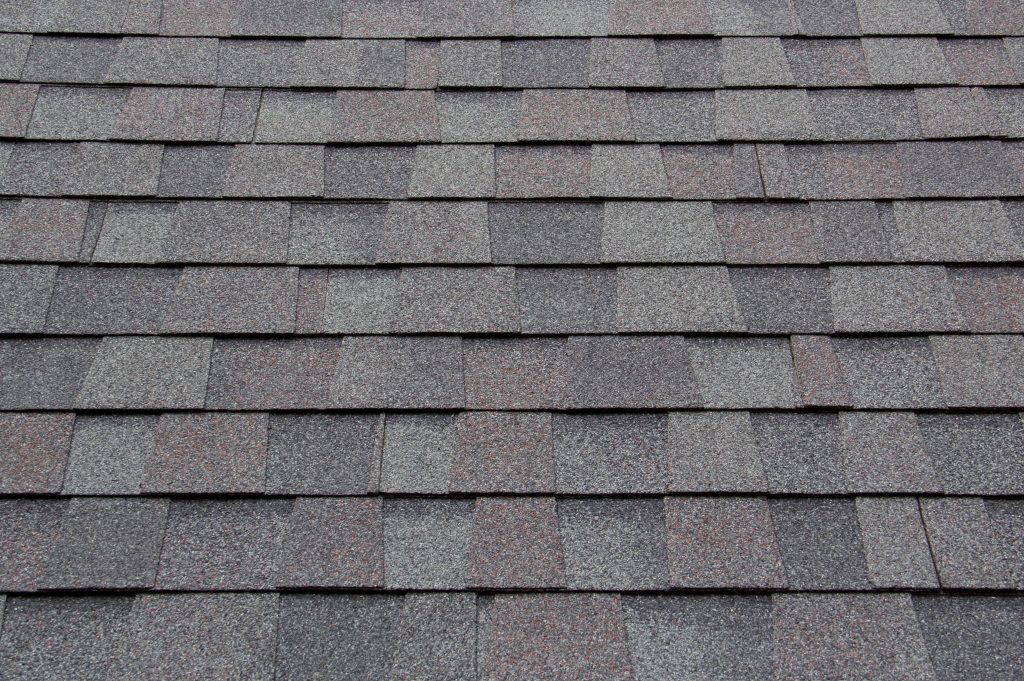 close up of gray asphalt shingles, one of the most popular roof replacement options
