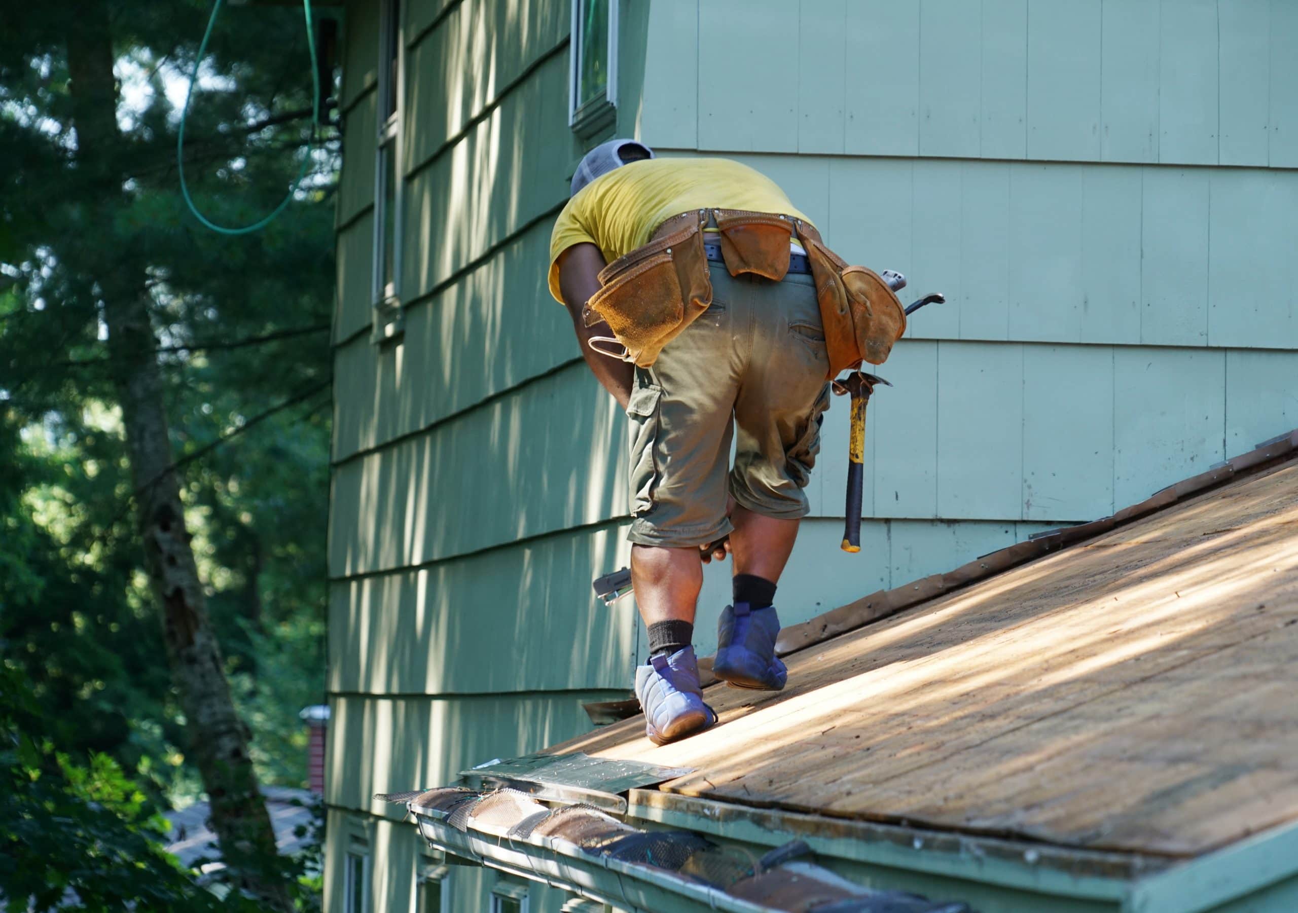 man working on a roof replacement