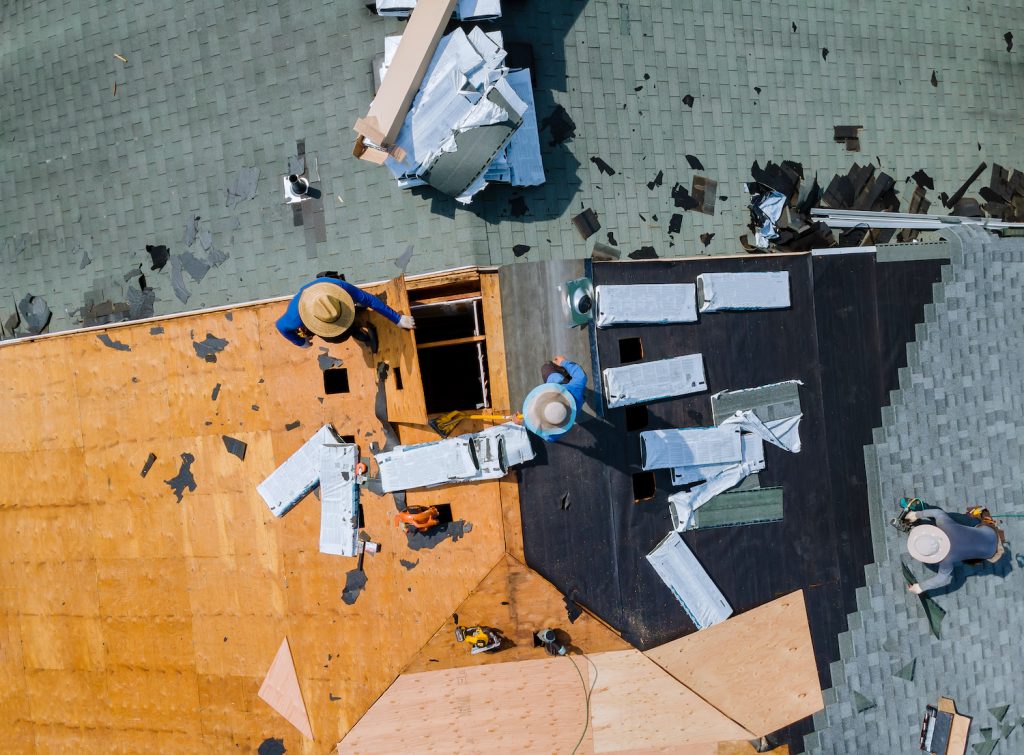 aerial view of roofer working on a roof replacement