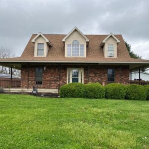 Brick home with new Mansard Roof By Gouge Quality Roofing